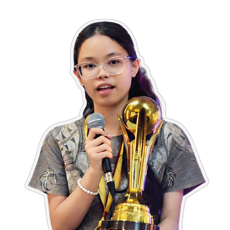 Hyacinth Kaye Bajuyo speaking at an event, holding a microphone and trophy